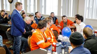 PM Trudeau sits and speaks to employees