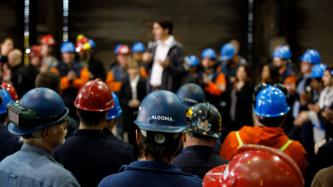 A group of Algoma employees watches PM Trudeau speak