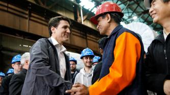 PM Trudeau shakes hands with an Algoma employee