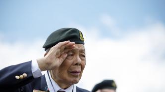 Canadian veteran George Chow render the military salute