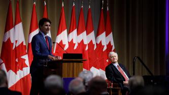 Former PM Turner sits and listens to PM Trudeau's speech