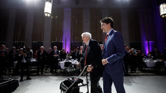 Attendees applaud former PM Turner and PM Trudeau