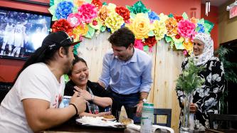 PM Trudeau and MP Zahid share a laugh with customers