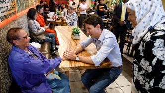 PM Trudeau and MP Zahid share a laugh with a customer