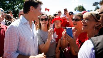 PM Trudeau speaks with women in a crowd