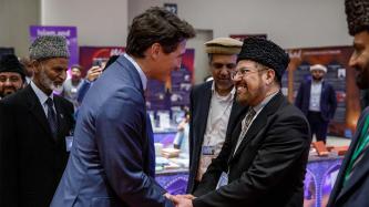 PM Trudeau shakes hands with a man