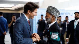 PM Trudeau shakes hands with a man