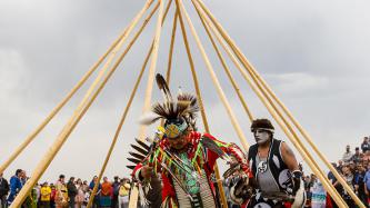 Two ceremony attendees perform a ceremonial dance