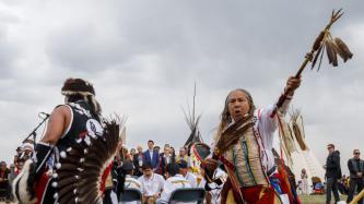 Two ceremony attendees perform a ceremonial dance