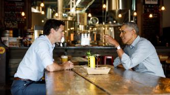 PM Trudeau listens to Barack Obama