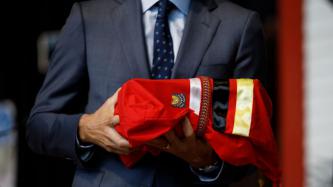 PM Trudeau holds a garment