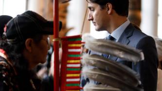 PM Trudeau stands with a woman