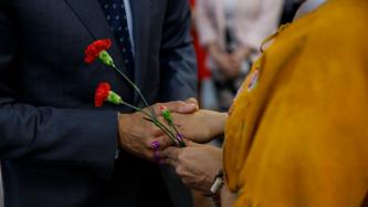 PM Trudeau shakes hands with a woman