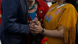 PM Trudeau shakes hands with a woman