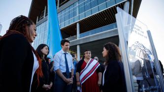 PM Trudeau and Minister Monsef listen to a woman