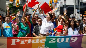 PM Trudeau waves to crowd in the Toronto Pride Parade