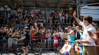 PM Trudeau waves to crowd in the Toronto Pride Parade