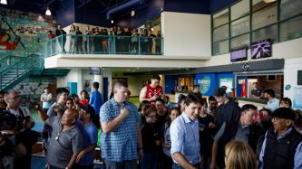 PM Trudeau shakes hands with a woman