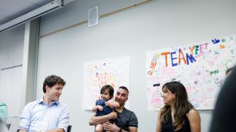 PM Trudeau speaks to a woman in the roundtable