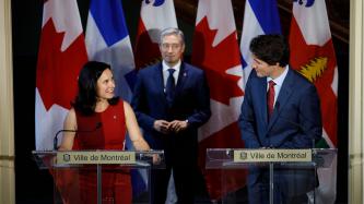 Prime Minister Trudeau speaks with Mayor Plante while Minister Champagne looks on