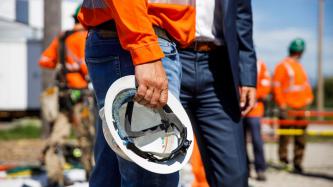 An employee holds a helmet