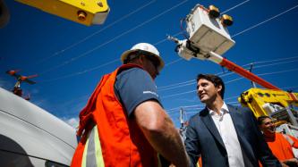PM Trudeau shakes hands with an employee