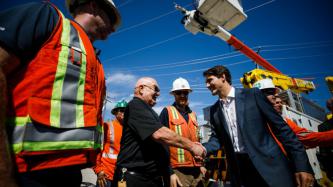 PM Trudeau shakes hands with an employee