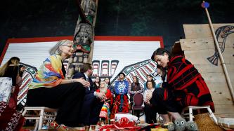 A group of men and women sit together