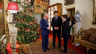 Prince Charles and PM Trudeau stand looking at Xavier Trudeau