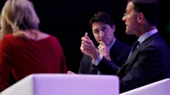 PM Justin Trudeau listens while PM Mark Rutte gestures with his hands