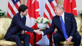 Prime Minister Trudeau and President Trump sit shaking hands