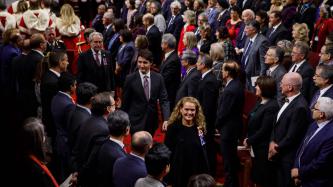 PM Trudeau and Gov. Gen. Payette walk in a procession in the Red Chamber