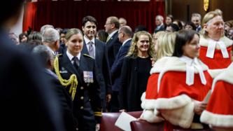 PM Trudeau and Gov. Gen. Payette walk in a procession in the Red Chamber