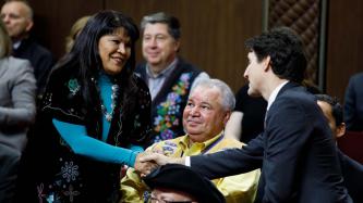 PM Trudeau shakes hands with a woman in the crowd 