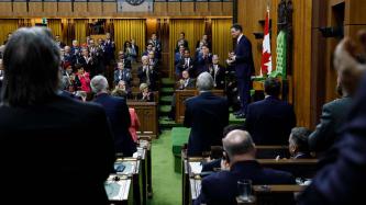 Anthony Rota stands at the Speaker’s Chair as Members of Parliament applaud