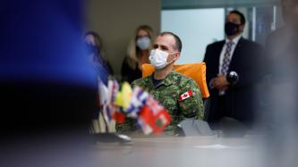 A member of the military sitting at a confernce table
