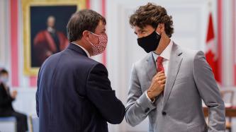 Prime Minister Trudeau elbow bumps Minister LeBlanc