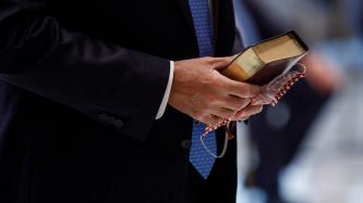 Minister LeBlanc holds a bible