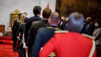 PM Trudeau stands among the audience in the Senate chamber