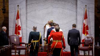 GG Julie Payette and PM Trudeau stand front and centre in the Senate chamber