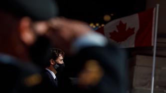 A soldier honours PM Trudeau with the military salute