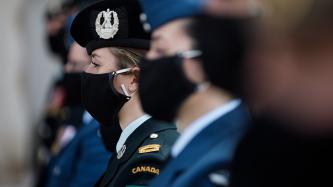 Members of CAF stand in a row and look on
