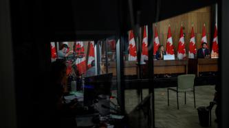 A view of PM Trudeau and Minister Joly from a window