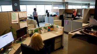 PM Trudeau stands near a group of women at their workstations
