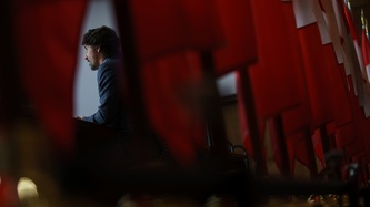 A view of PM Trudeau, behind the Canadian flags