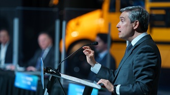 Minister Champagne speaks at the podium