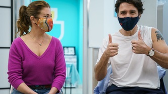 Sophie Grégoire Trudeau looks on as Prime Minister Trudeau gives thumbs-up