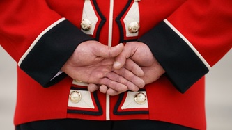 A member of the Royal Guard with hands behind back