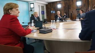 View of a meeting underway with leaders seated at a large round table