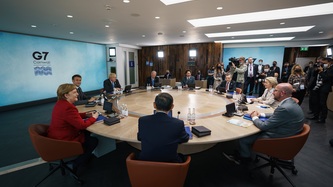 View of a meeting underway with leaders seated at a large round table
